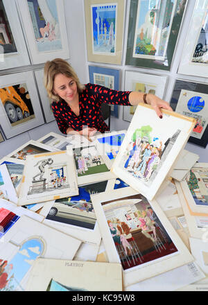 Auctioneer Catherine Southon holds examples from the Smilby cartoon collection, including works that appeared in Playboy, at the Ripley Arts Centre, Bromley, ahead of their auction next month. Stock Photo