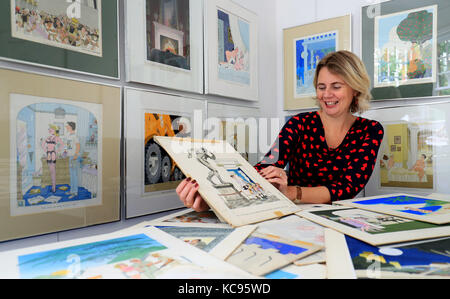 Auctioneer Catherine Southon holds examples from the Smilby cartoon collection, including works that appeared in Playboy, at the Ripley Arts Centre, Bromley, ahead of their auction next month. Stock Photo