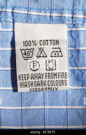 wash care symbols and instructions on label in woman's top from Marks ...