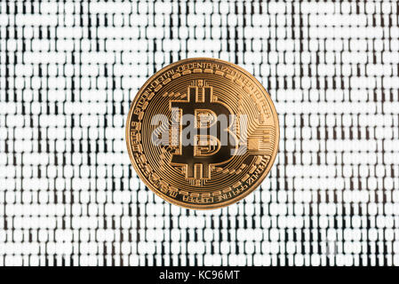 Bitcoin on binary code blurred background Stock Photo