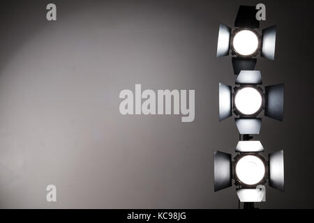 Several reflectors on the black background in photo studio. Stock Photo