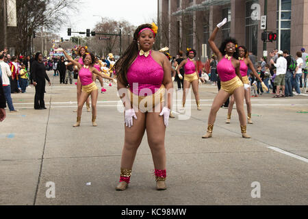 Baton Rouge, Louisiana, USA - 2016: Girls participate in a parade during Mardi Gras celebrations. Stock Photo