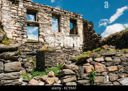 Stepantsminda Gergeti, Georgia. Old Abandoned Dilapidated Ruined House In Village. Kazbegi District, Mtskheta-Mtianeti Region, Georgia. Spring Or Summ Stock Photo