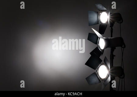 Several reflectors on the black background in photo studio. Stock Photo