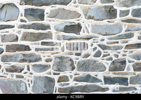Historic Stone Wall Detail from 1700's residence with raised mortar joints. Stock Photo