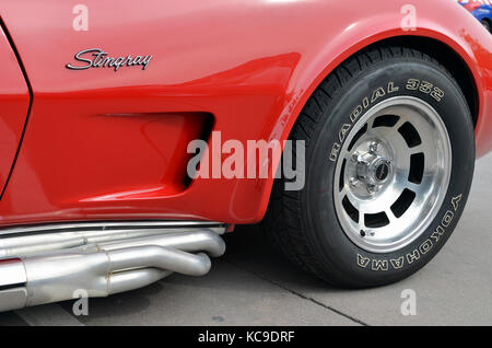 Meeting of classic american cars, in the streets of Torrejon de Ardoz (Madrid - Spain). Front wheel of red Chevrolet Corvette C3 Stingray Stock Photo