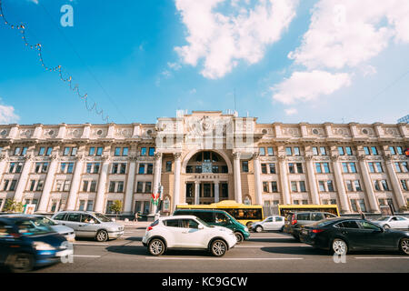 Minsk, Belarus. View Of Busy Traffic On Independence Avenue, Facade Of Central Post Office Building Of Stalinist Empire Style Or Socialist Classicism  Stock Photo