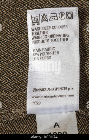 Care washing symbols and instructions on label in Marks and Spencer woman's clothing main fabric 62% polyester 38% cupro Stock Photo