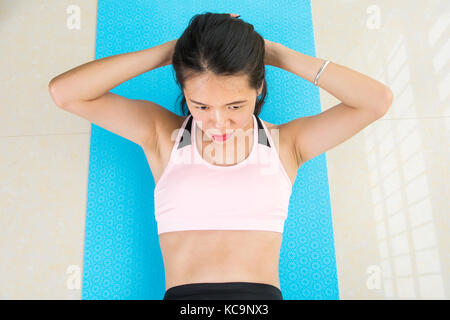 Girl doing crunches on the balcony. Home workout Stock Photo