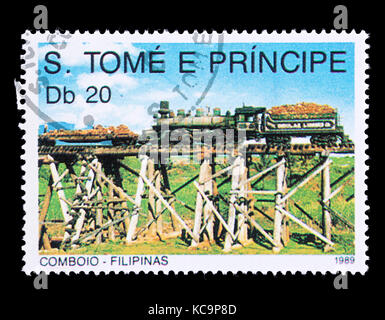 Postage stamp from Saint Thomas and Prince Islands depicting a Filipino steam locomotive and tender on a wooden trestle bridge. Stock Photo