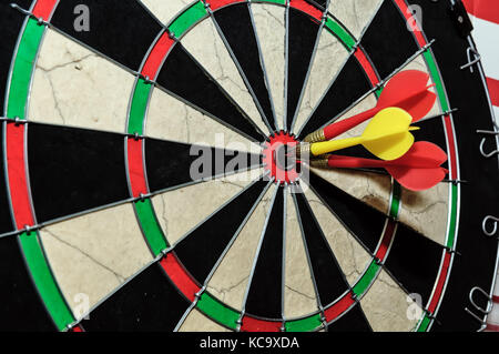 Three darts arrows in the target center in bull's eye. Business goal concept Stock Photo