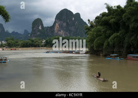 Old Chinese fisherman on bamboo draft with cormorants on Li River near Xingping, between Yangshuo and Guilin, Guangxi, China, Asia Stock Photo