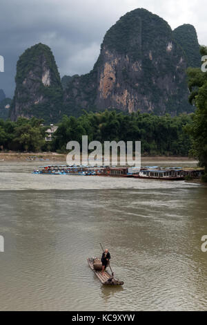 Old Chinese fisherman on bamboo draft with cormorants on Li River near Xingping, between Yangshuo and Guilin, Guangxi, China, Asia Stock Photo