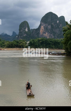 Old Chinese fisherman on bamboo draft with cormorants on Li River near Xingping, between Yangshuo and Guilin, Guangxi, China, Asia Stock Photo