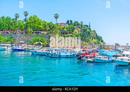 ANTALYA, TURKEY - MAY 12, 2017: Historic marina is the perfect place to relax, enjoy the views and choose the sea trip or fishing tour, on May 12 in A Stock Photo