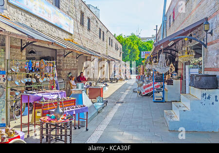 ANTALYA, TURKEY - MAY 12, 2017: The stores of metalwork market, located in old town and offering many souvenirs, tableware and other interesting goods Stock Photo