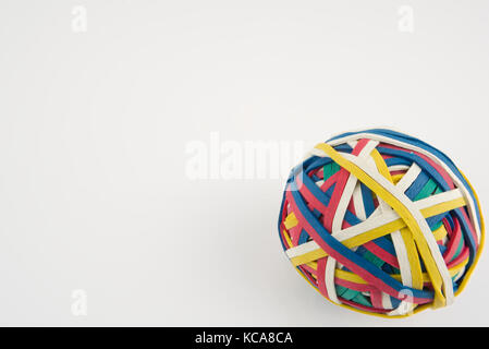 Rubber band ball made from many colourful elastic bands isolated on a white background Stock Photo