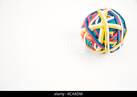 Rubber band ball made from many colourful elastic bands isolated on a white background Stock Photo