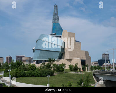 Canadian Museum for Human Rights building from the Esplanade Riel pedestrian bridge across the Red River, The Forks National Historic Site, Winnipeg,  Stock Photo