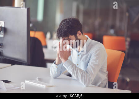young business man working on desktop computer at his desk in modern bright startup office interior Stock Photo