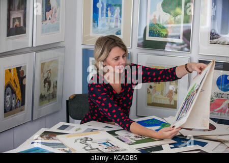 Bromley, UK. 3rd October, 2017. Auctioneer Catherine Southon poses with cartoons by Smilby (Francis Wilford-Smith, 1927-2009), one of the most successful cartoonists of his day and best known for his work for Playboy and Punch. Part 1 of the Smilby Cartoon Collection will be auctioned by Catherine Southon Auctioneers & Valuers on 1st November 2017. Credit: Mark Kerrison/Alamy Live News Stock Photo