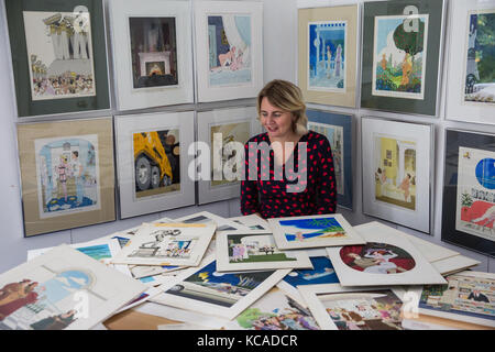 Bromley, UK. 3rd October, 2017. Auctioneer Catherine Southon poses with cartoons by Smilby (Francis Wilford-Smith, 1927-2009), one of the most successful cartoonists of his day and best known for his work for Playboy and Punch. Part 1 of the Smilby Cartoon Collection will be auctioned by Catherine Southon Auctioneers & Valuers on 1st November 2017. Credit: Mark Kerrison/Alamy Live News Stock Photo