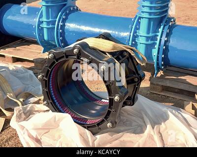 500mm new black axe joint unit. 500 mm drink water Gate valve joint with screws and nuts to pipe fitting. Piping repair, unit on wooden pallet. Stock Photo