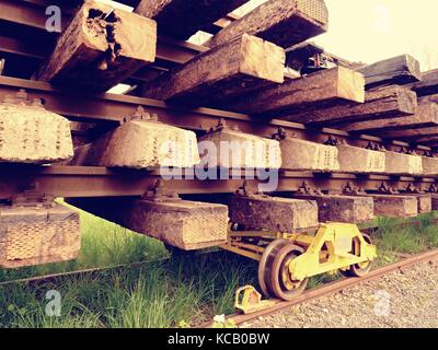 Recycling company stock. Rail platform with old concrete and wooden sleepers extracted  with rail rods waiting for transport to steel foundry for reme Stock Photo