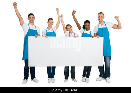 Group Of A Janitors Cheering While Holding Blank Banner On White Background Stock Photo