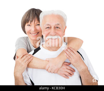 Portrait Of Senior Couple Embracing Each Other On White Background Stock Photo