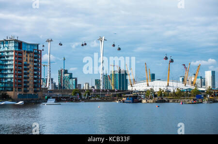 Scene across Royal Victoria Dock (mainly used for water sports) to Greenwich, with the O2 Arena, cable cars and apartment blocks, London, England, UK.