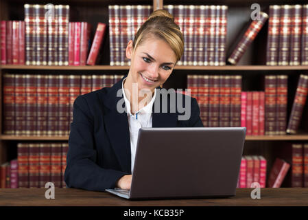 Portrait Of A Young Female Accountant Using Laptop In A Courtroom Stock Photo