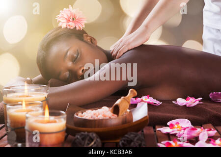 Young African Woman Receiving Back Massage At Beauty Spa Stock Photo