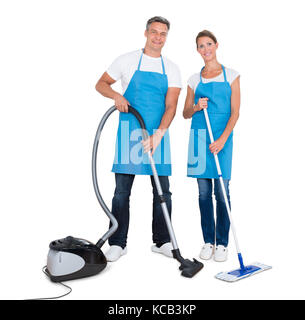 Portrait Of A Two Janitors With Vacuum Cleaner And Mop Standing On White Background Stock Photo