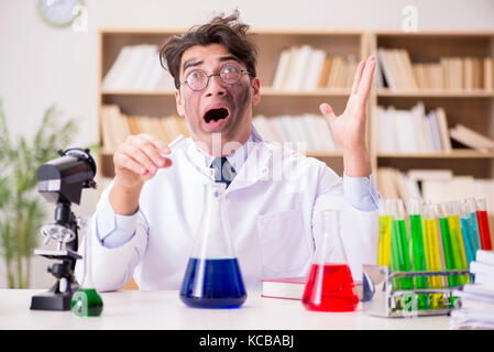 Mad crazy scientist doctor doing experiments in a laboratory Stock Photo