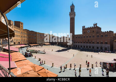 Siena, Siena Province, Tuscany, Italy.  The Palazzo Pubblico with the Torre de Mangia seen across the Piazza del Campo.  The Historic Centre of Siena  Stock Photo