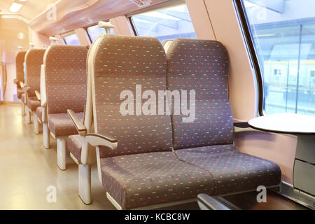 Interior of modern european train. New empty railway carriage. Stock Photo