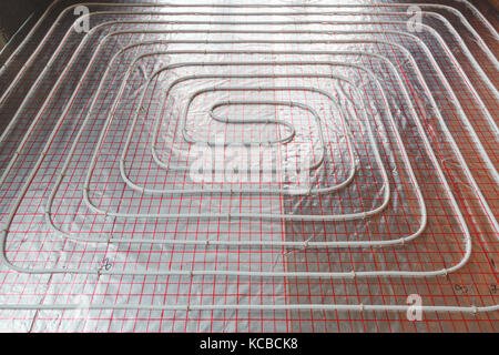 Underfloor heating installation. Close up on water floor system interior. plumbing pipes. Individual . Stock Photo