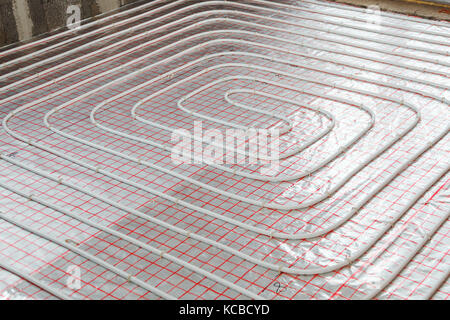 Underfloor heating installation. Close up on water floor system Stock Photo