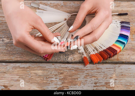 Woman hands holding summer nail samples. Stock Photo