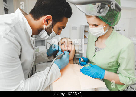 Young talented arabic dentist and his assistant nurse at work Stock Photo