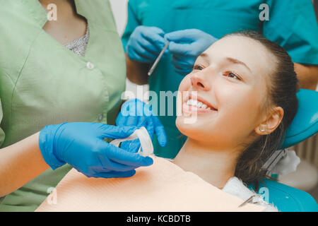 Doctor dentist takes retractor during the examination of the oral cavity Stock Photo