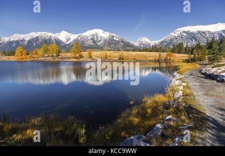 Autumn Landscape and Distant Rocky Mountains Tops from Quarry Lake above Canmore in Alberta Foothills near Banff National Park Canada Stock Photo