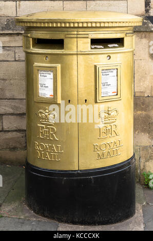 Golden coloured British Roayl Mail pillar post box in Wiltshire England UK Stock Photo