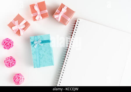 Festive composition. boxes with gifts and note, on a white table with copy space. Top view Stock Photo