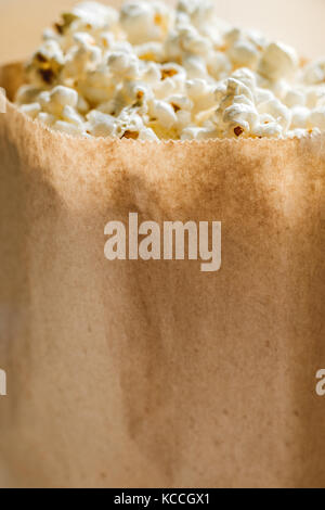 Popcorn in paper bio ecological bag. Copy space, close up Stock Photo