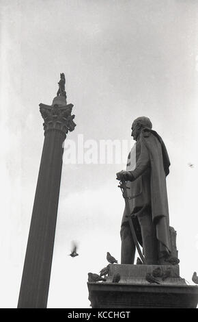 Historical picture from the 1940s showing the famous Nelson's Column at London's Trafalgar Square, with the statue of Major-General Sir Henry Havelock on a plinth, with pigeons, on the base. Stock Photo