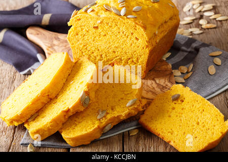 Freshly baked pumpkin bread with seeds close-up on the table. horizontal Stock Photo