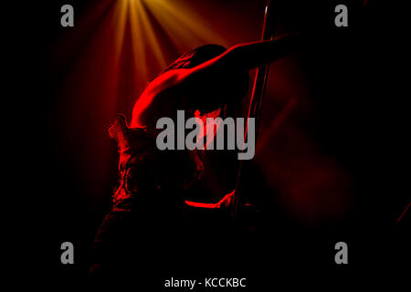 Image of girl preforming dance on a pole in a night club. night life activity, back lights. Stock Photo