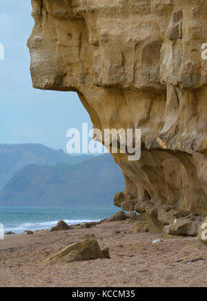 Sandstone cliff overhang at West Bay, with Golden cap in background, Dorset, England Stock Photo